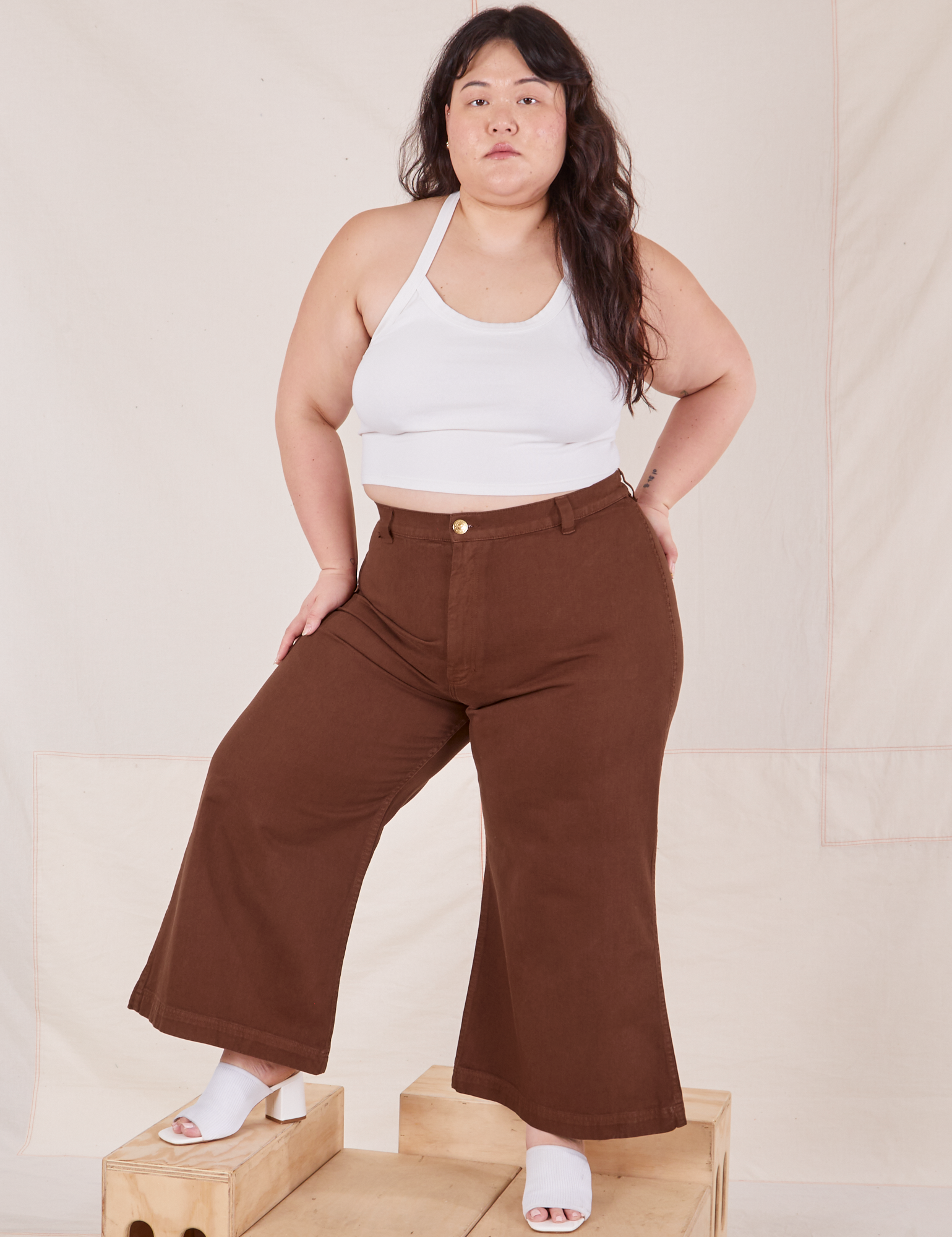Ashley is 5&#39;7&quot; and wearing 1XL Petite Bell Bottoms in Fudgesicle Brown paired with vintage off-white Halter Top