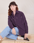 Alex is wearing a buttoned up Corduroy Overshirt in Nebula Purple and light wash Denim Trouser Jeans