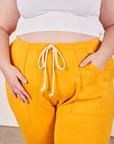 Cropped Rolled Cuff Sweatpants in Mustard Yellow front close up on Marielena