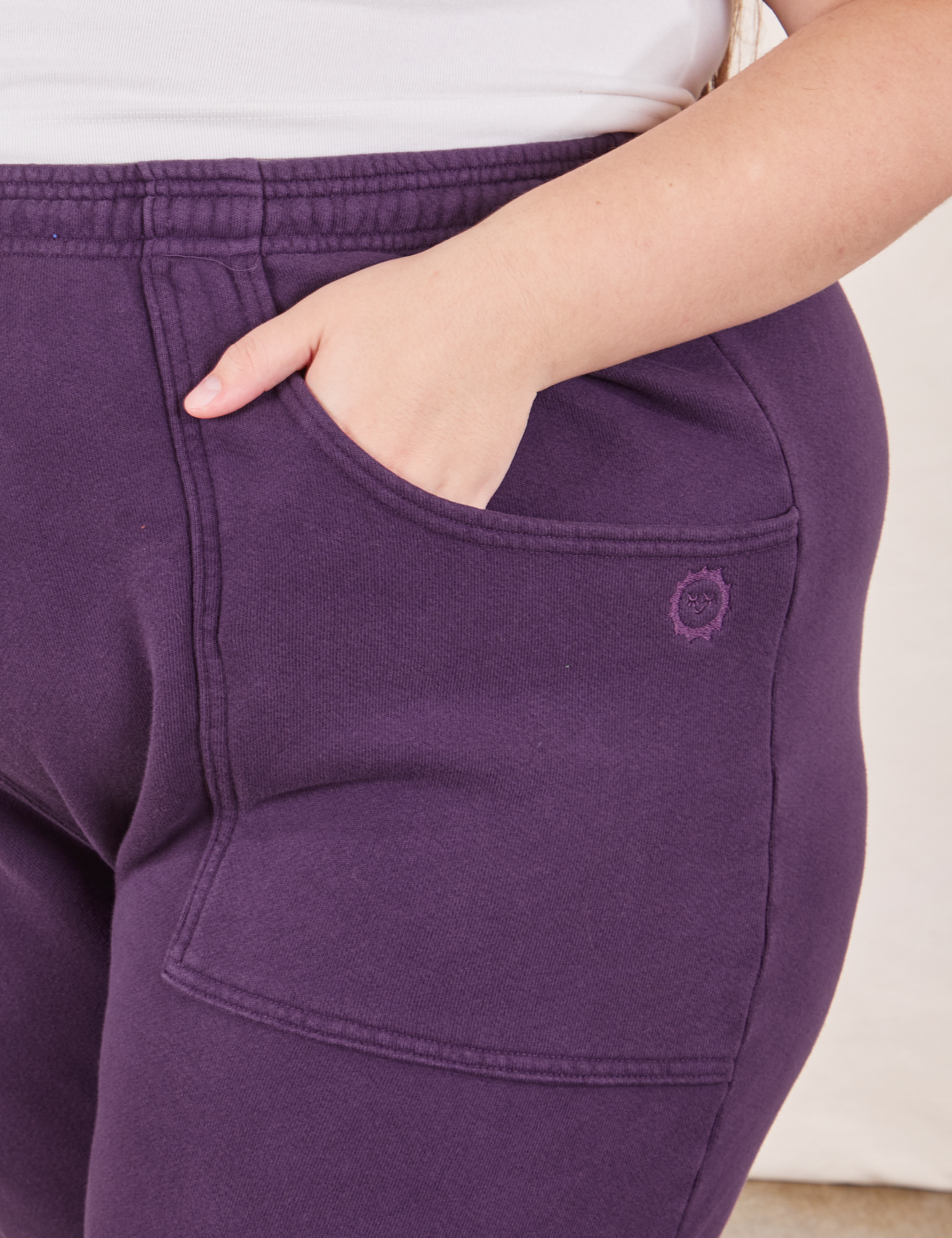 Cropped Rolled Cuff Sweatpants in Nebula Purple front pocket close up.  Marielena has her hand in the pocket.