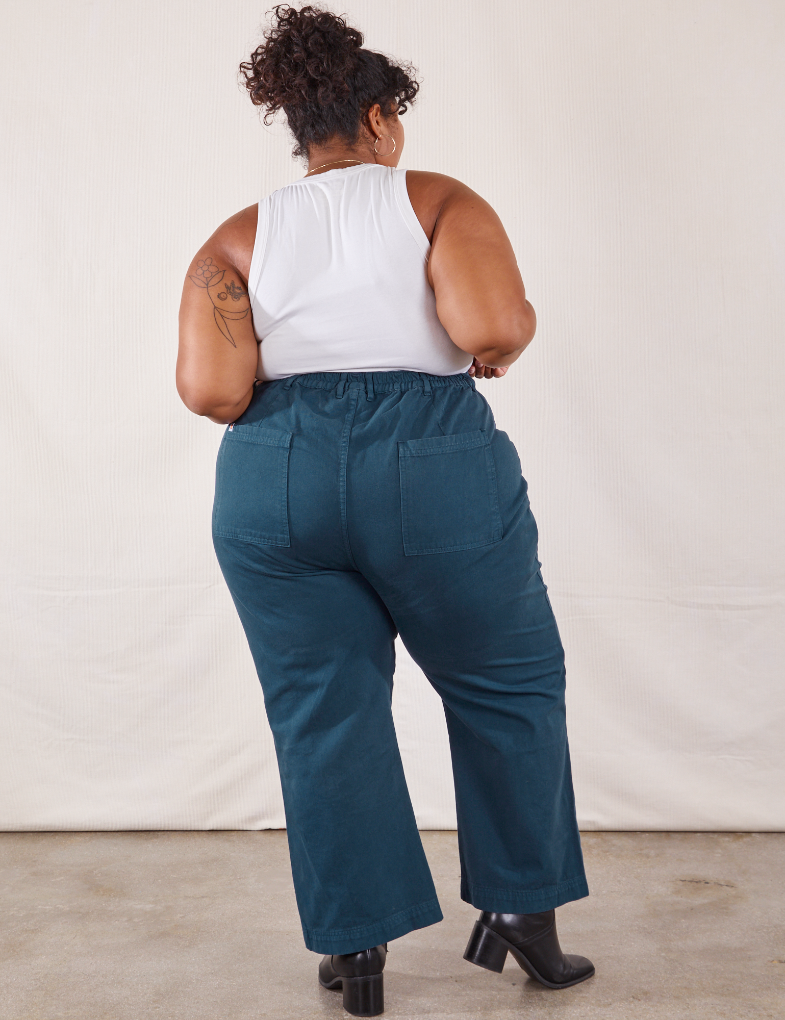 Back view of Western Pants in Lagoon and vintage tee off-white Tank Top on Morgan