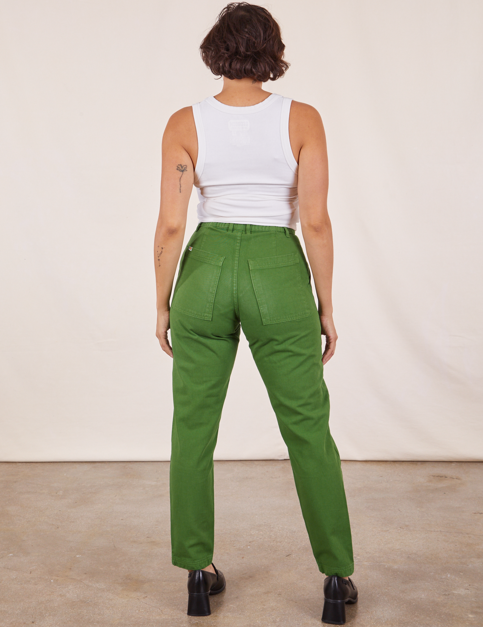 Back view of Pencil Pants in Lawn Green and vintage off-white Cropped Tank Top on Tiara