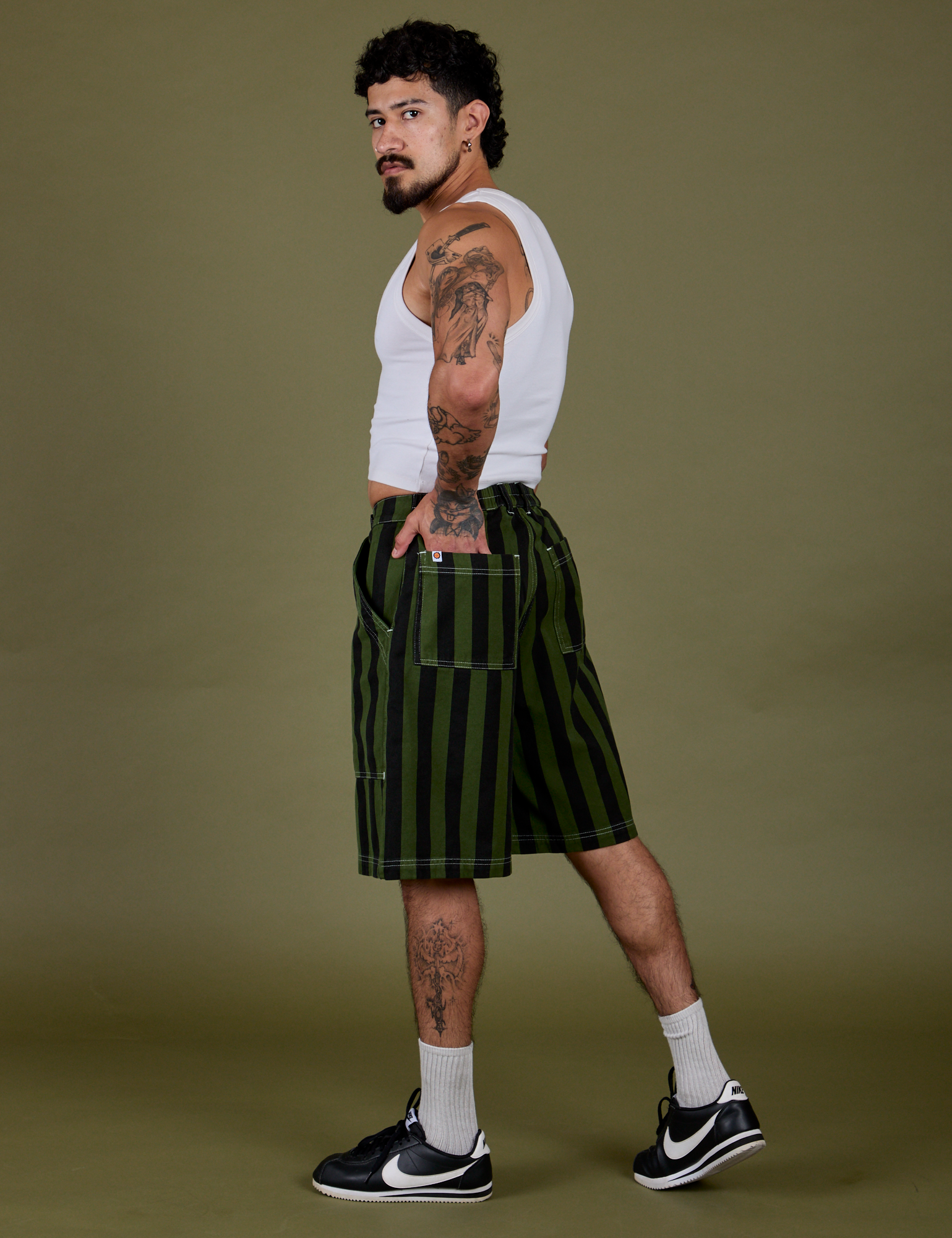 Side view of Longline Work Shorts in Evergreen and Cropped Tank in Vintage Tee White on Jesse