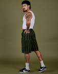 Side view of Longline Work Shorts in Evergreen and Cropped Tank in Vintage Tee White on Jesse