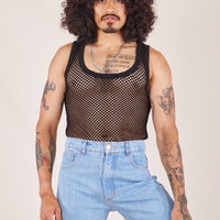 Jesse is wearing Mesh Tank Top in Basic Black tucked into light wash Sailor Jeans