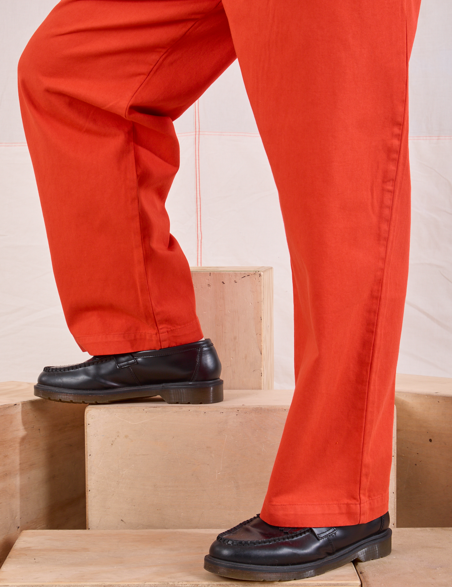 Mid-Rise Pleated Trousers in Chili Red pant leg close up on Issac