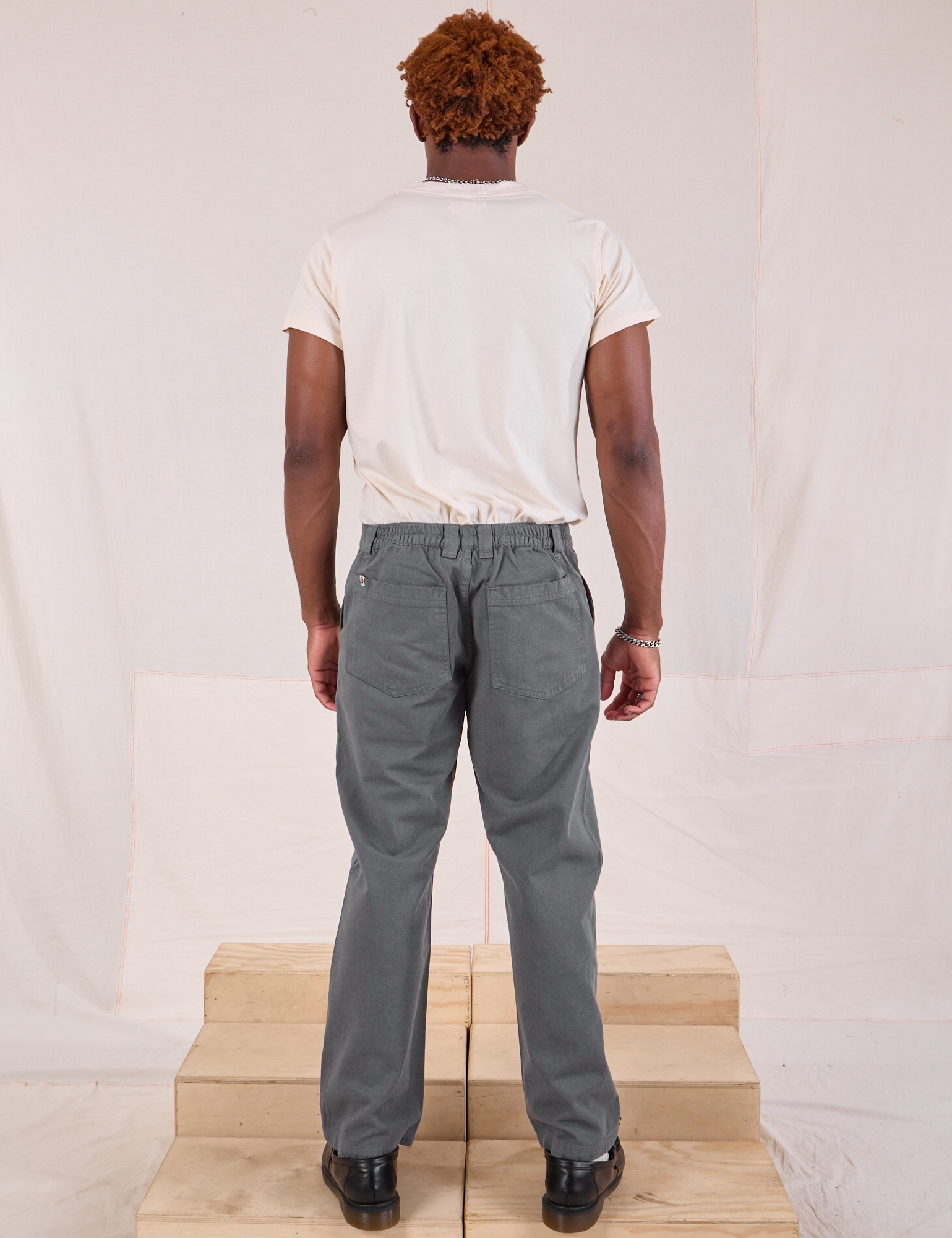 Back view of Mid-Rise Work Pants in Slate Grey and Organic Vintage Tee in vintage tee off-white on Issac