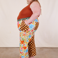 Side view of Mismatched Print Work Pants and burnt terracotta Tank Top worn by Catie
