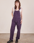 Hana is 5'3" and wearing P Original Overalls in Mono Nebula Purple