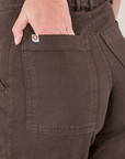 Pencil Pants in Espresso Brown back pocket close up. Scarlett has her hand in the pocket.
