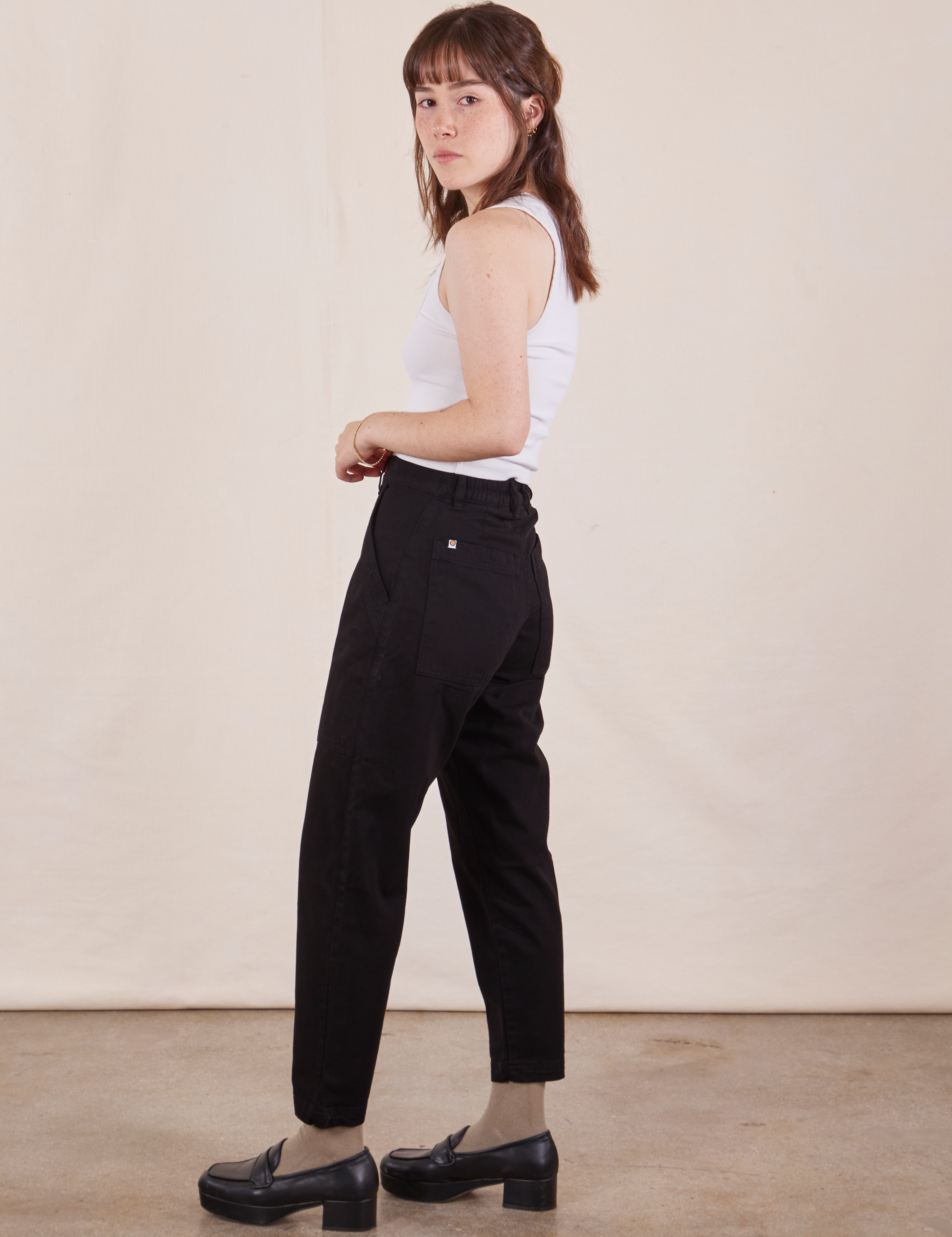 Side view of Petite Pencil Pants in Basic Black and vintage off-white Cropped Tank Top on Hana