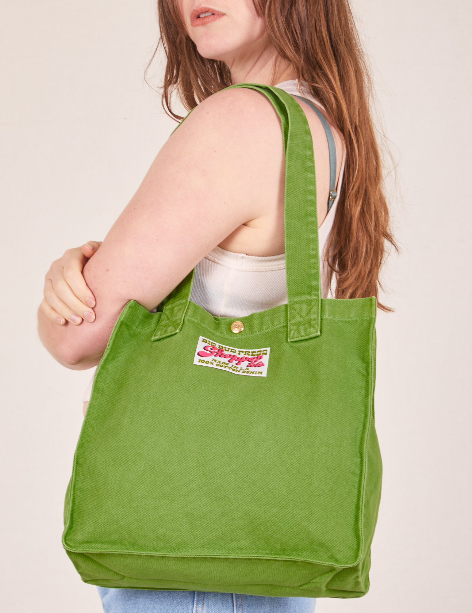 Shopper Tote Bag in Bright Olive worn over shoulder by Allison