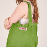 Shopper Tote Bag in Bright Olive worn over shoulder by Allison