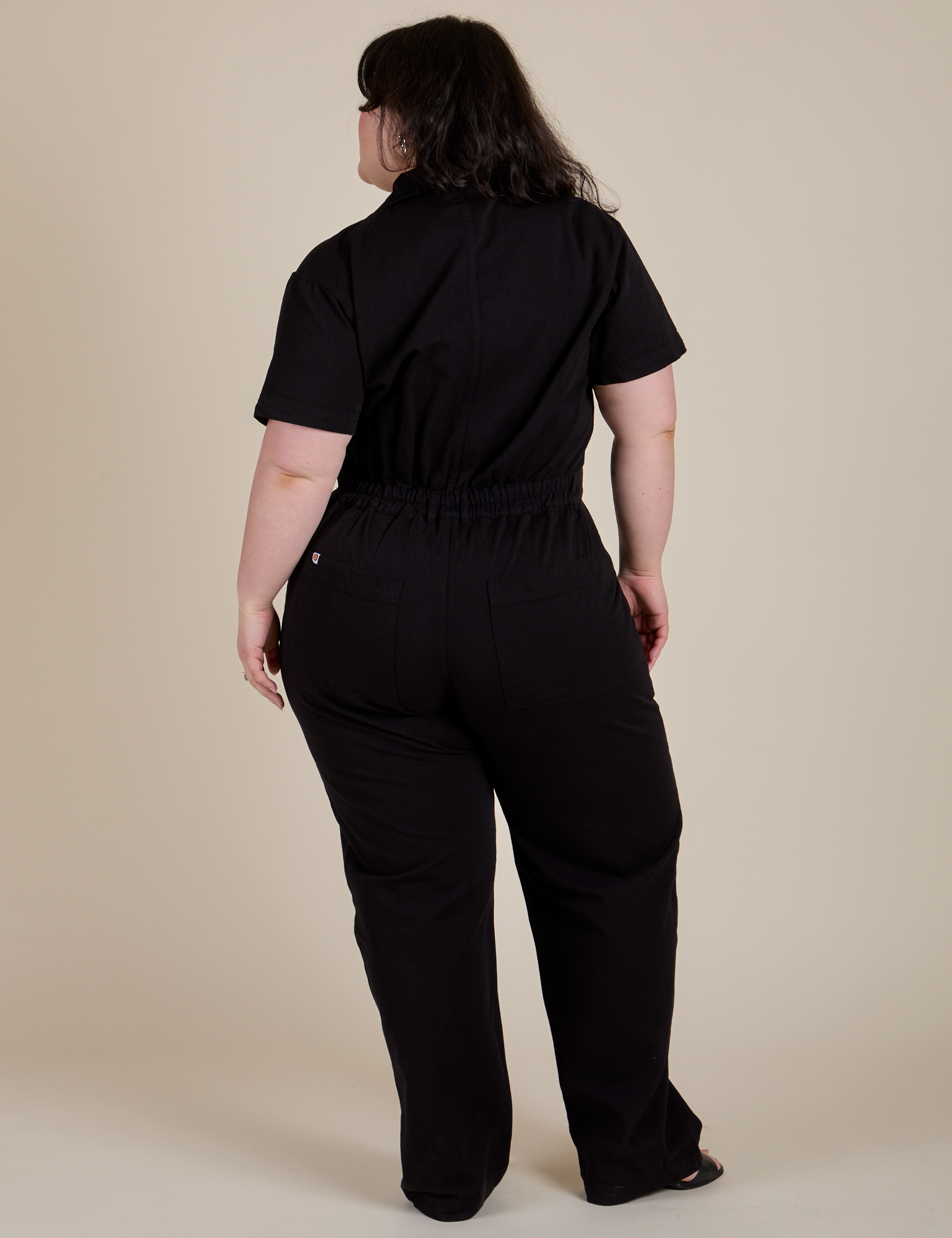 Short Sleeve Jumpsuit in Basic Black back view on Ashley