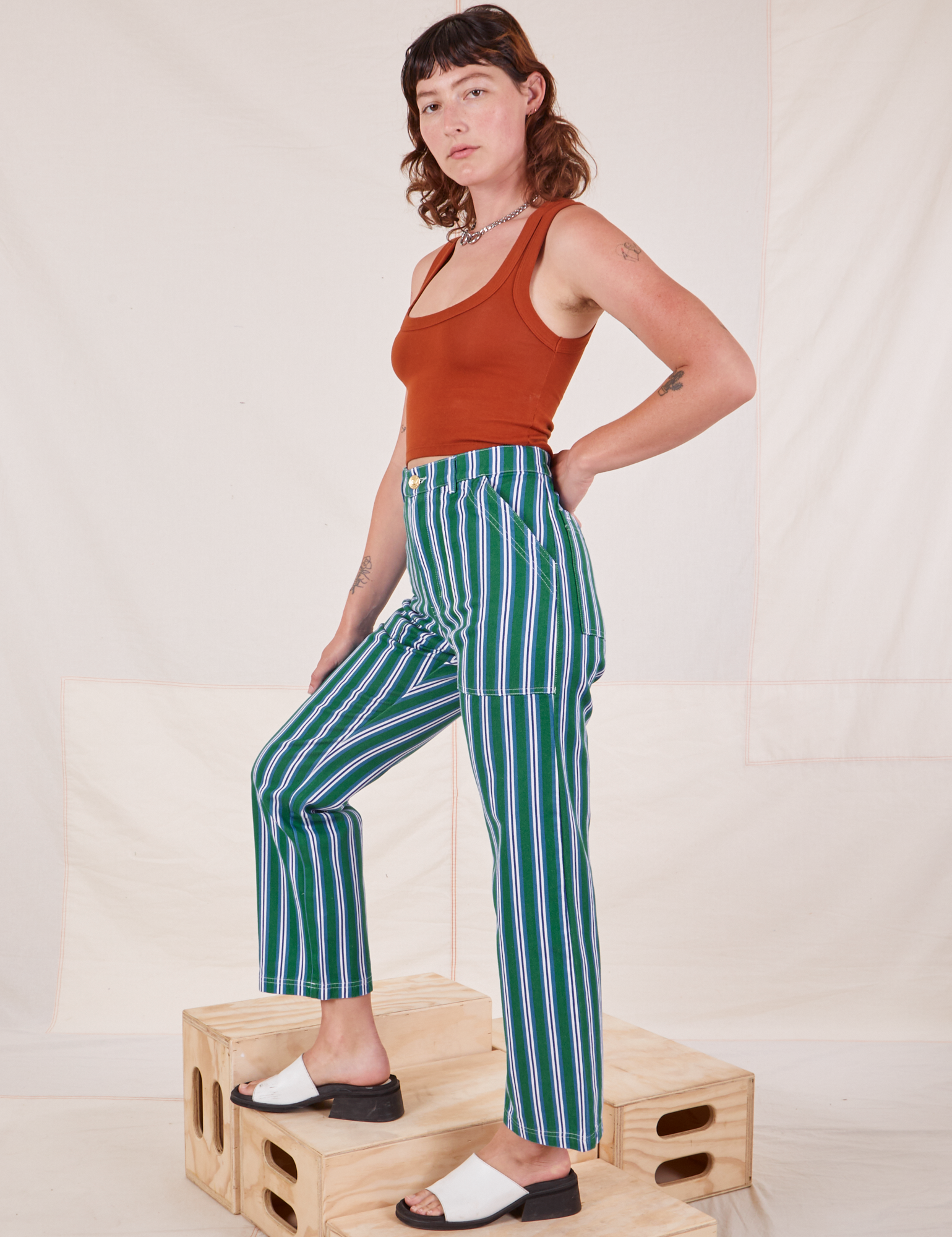 Side view of Stripe Work Pants in Green and burnt terracotta Cropped Tank Top