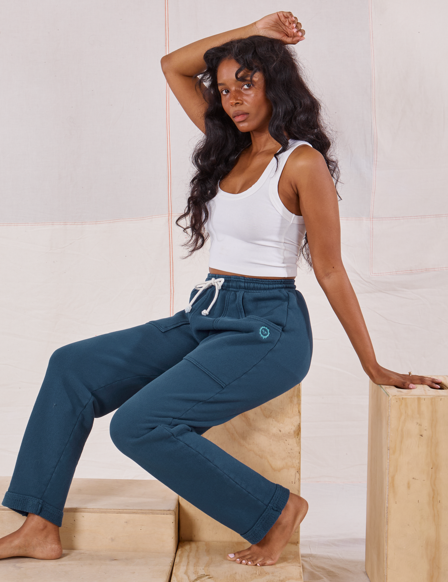 Kandia is wearing Rolled Cuff Sweat Pants in Lagoon and Cropped Tank in vintage tee off-white 