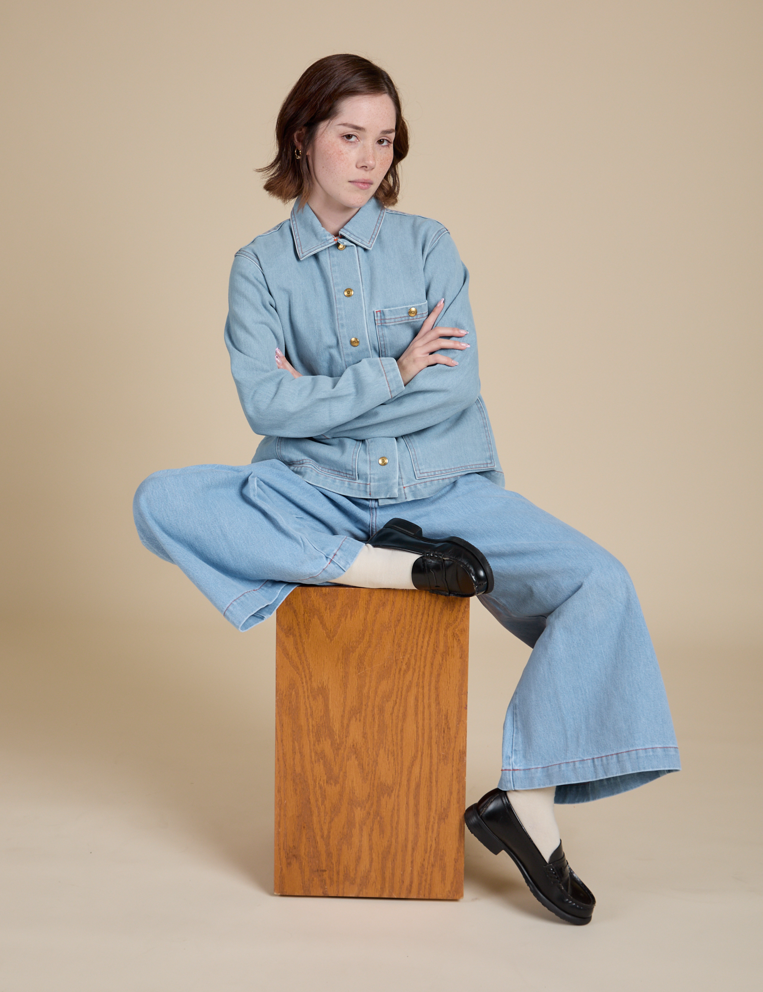 Hana is wearing Indigo Denim Work Jacket in Light Wash and Indigo Wide Leg Trousers in Light Wash