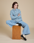 Hana is wearing Indigo Denim Work Jacket in Light Wash and Indigo Wide Leg Trousers in Light Wash