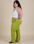 Side view of Work Pants in Gross Green and Cropped Tank in Vintage Tee White on Ashley