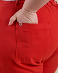 Close up of Ashley's hand in the back pocket of Work Pants in Mustang Red