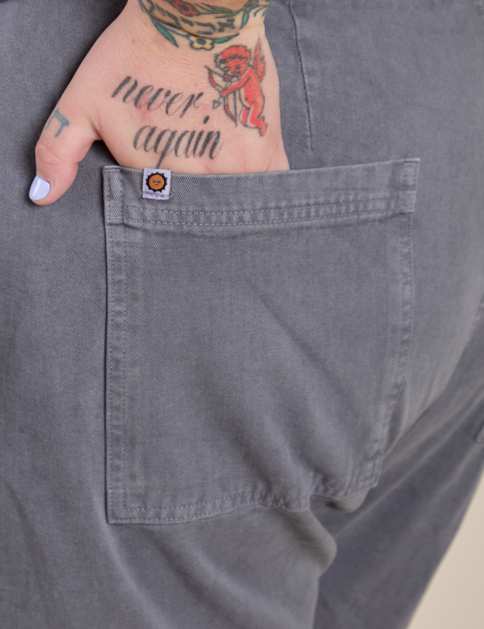 Close up of Sam's hand in the back pocket of Work Pants in Washed Grey
