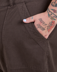 Close up of Sam's hand in the front pocket of Work Pants in Espresso Brown