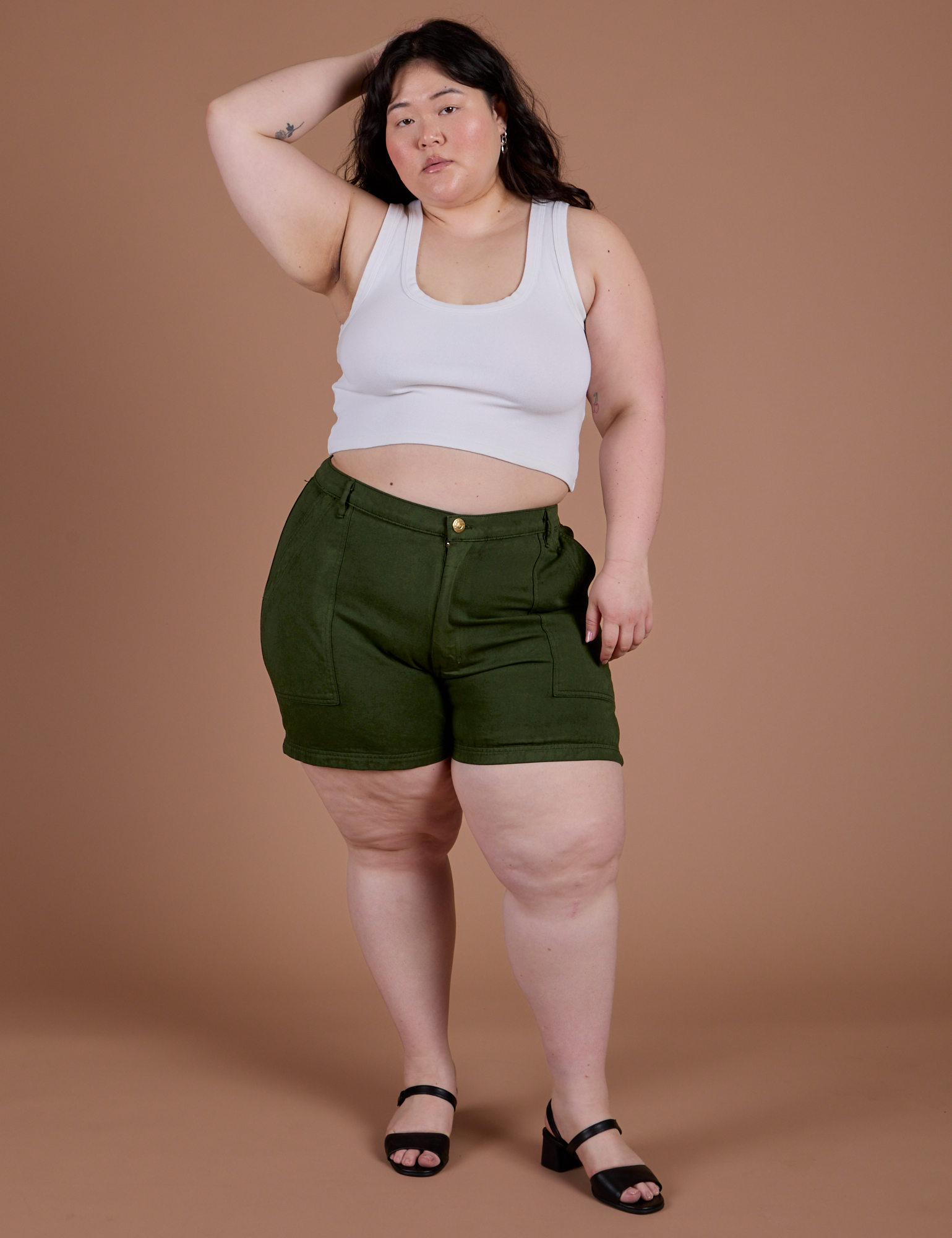 Ashley is wearing Classic Work Shorts in Evergreen and Cropped Tank in Vintage Tee White