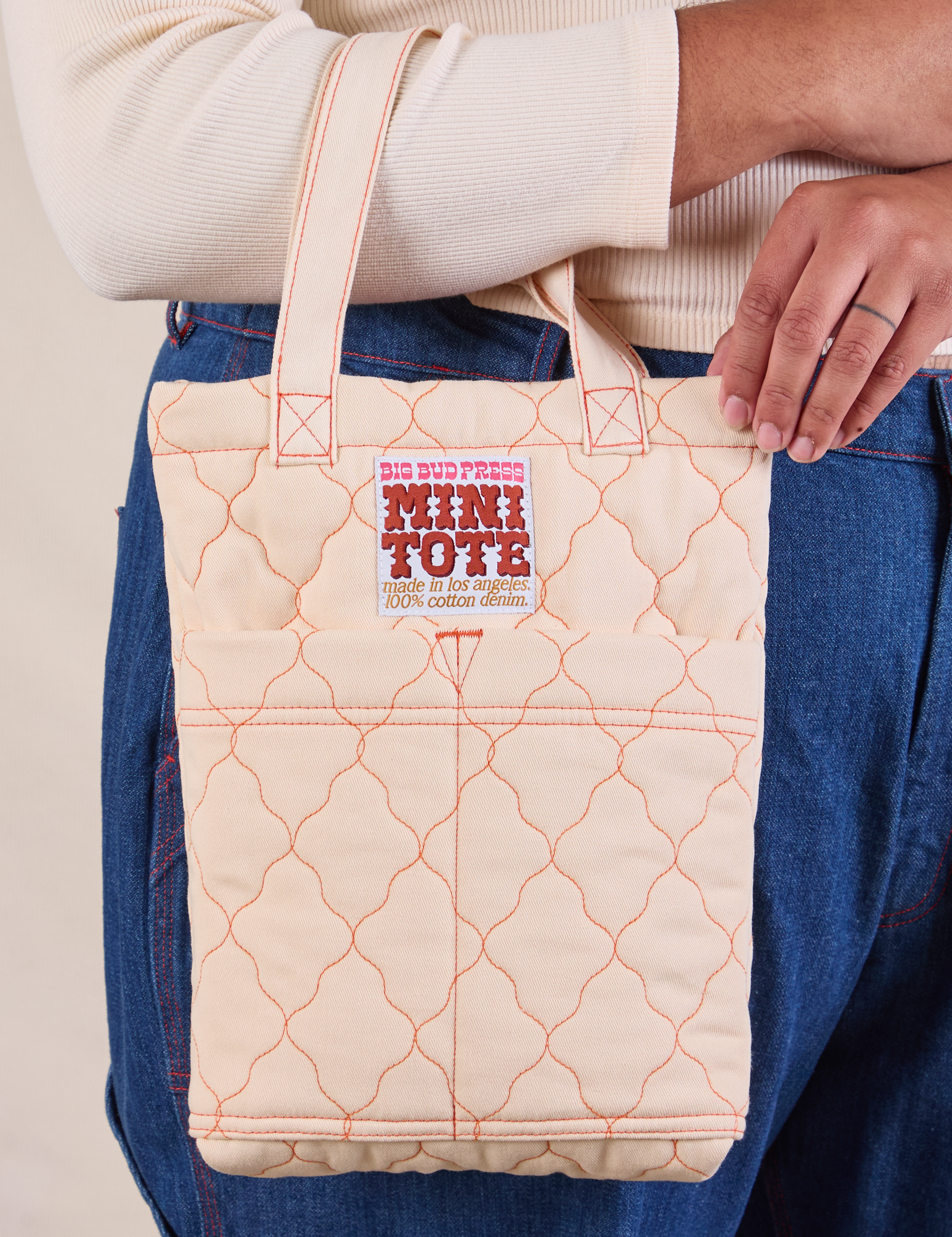 Quilted Mini Tote in Vintage Tee Off-White worn on model&#39;s arm