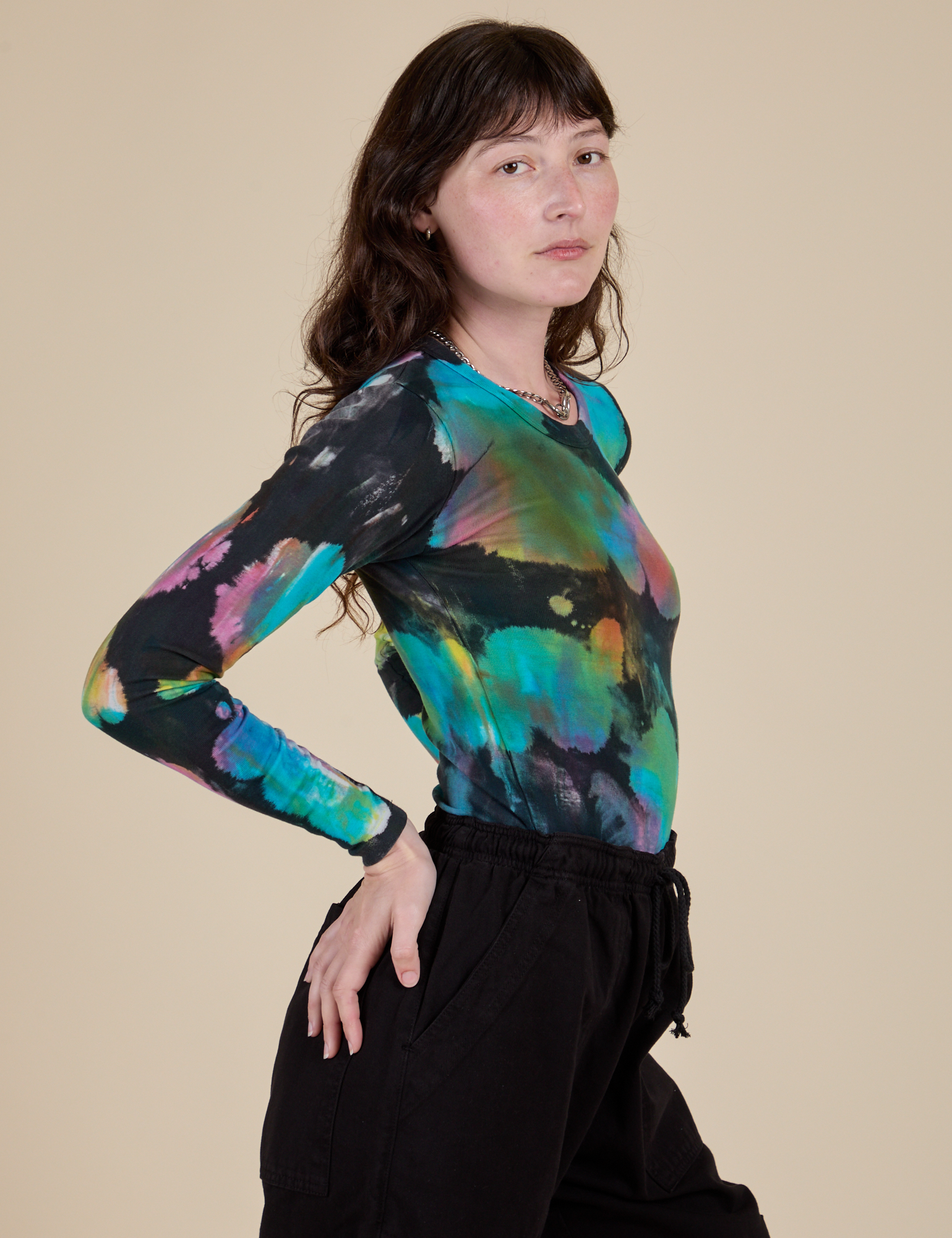 Long Sleeve Baby Tee in Rainbow Magic Waters side view on Alex