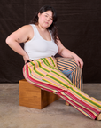 Mixed Stripe Work Pants worn by Ashley sitting on a wooden box