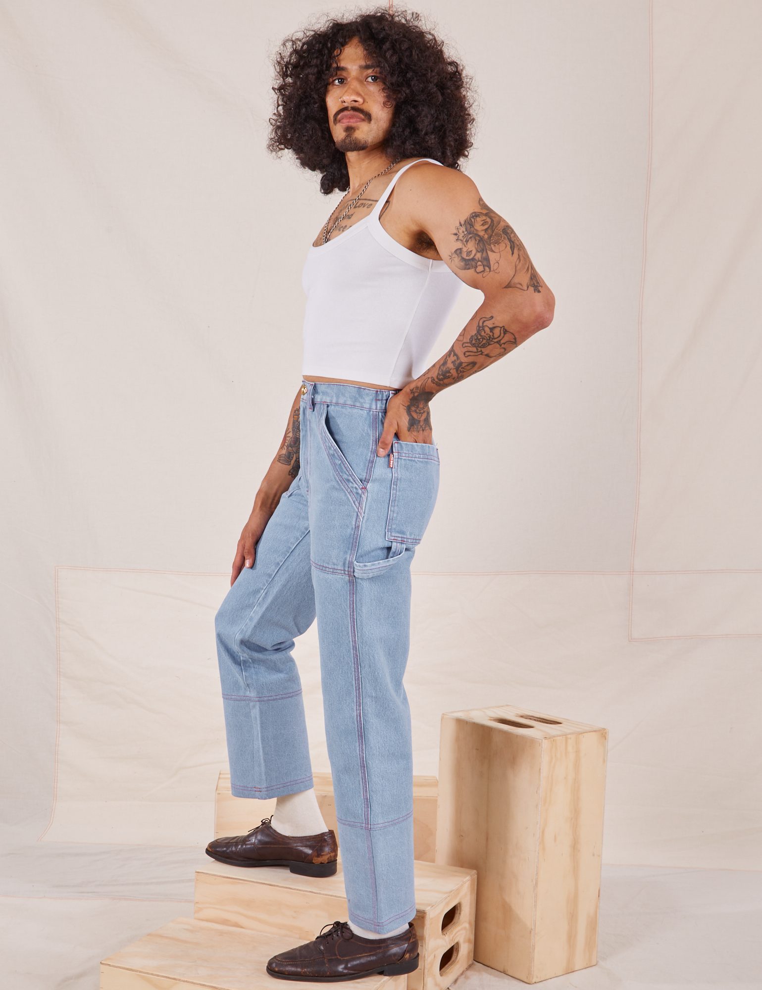 Side view of Carpenter Jeans in Light Wash worn by Jesse