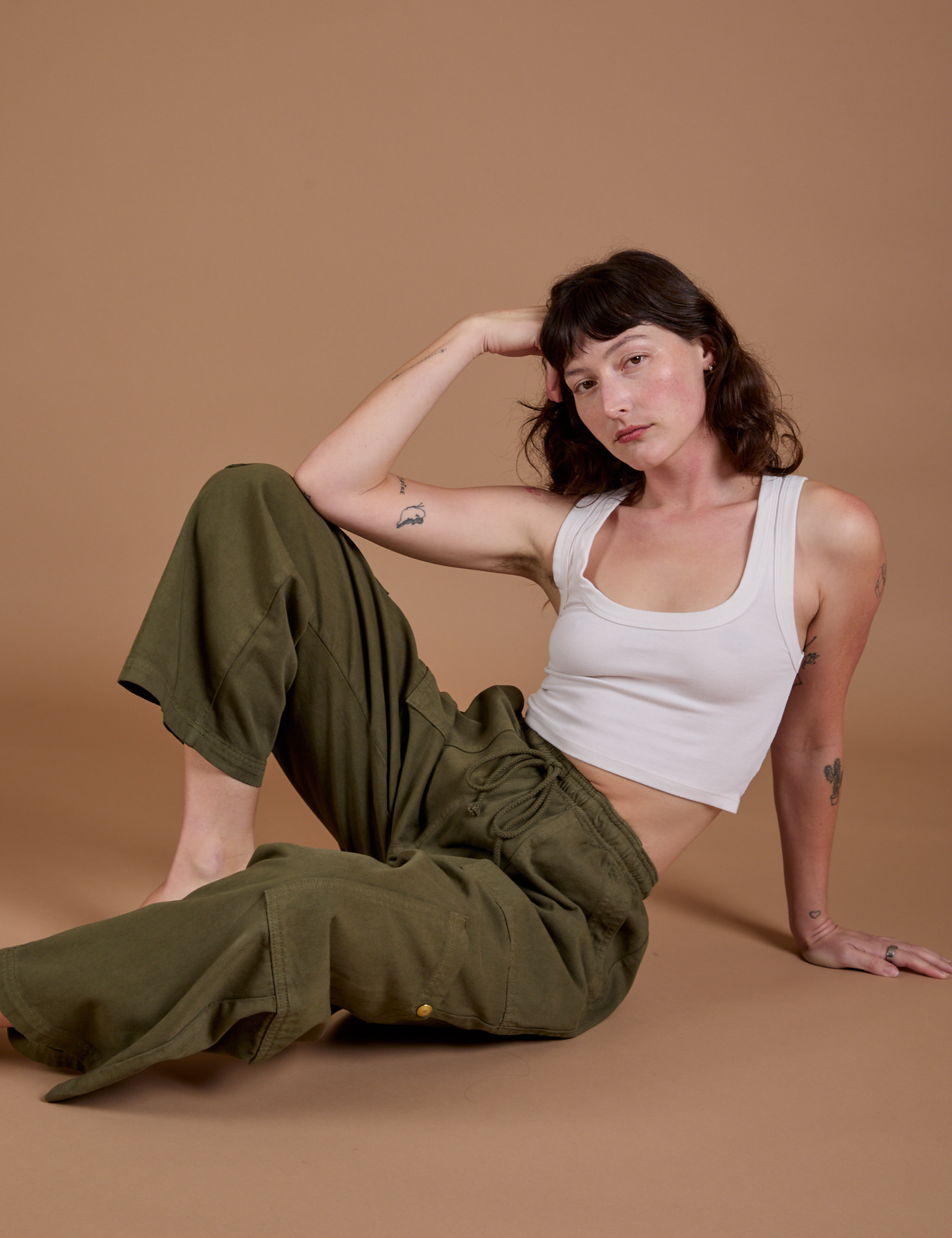 Drop Pocket Cargo Pants in Surplus Green and Cropped Tank in vintage tee white worn by Alex