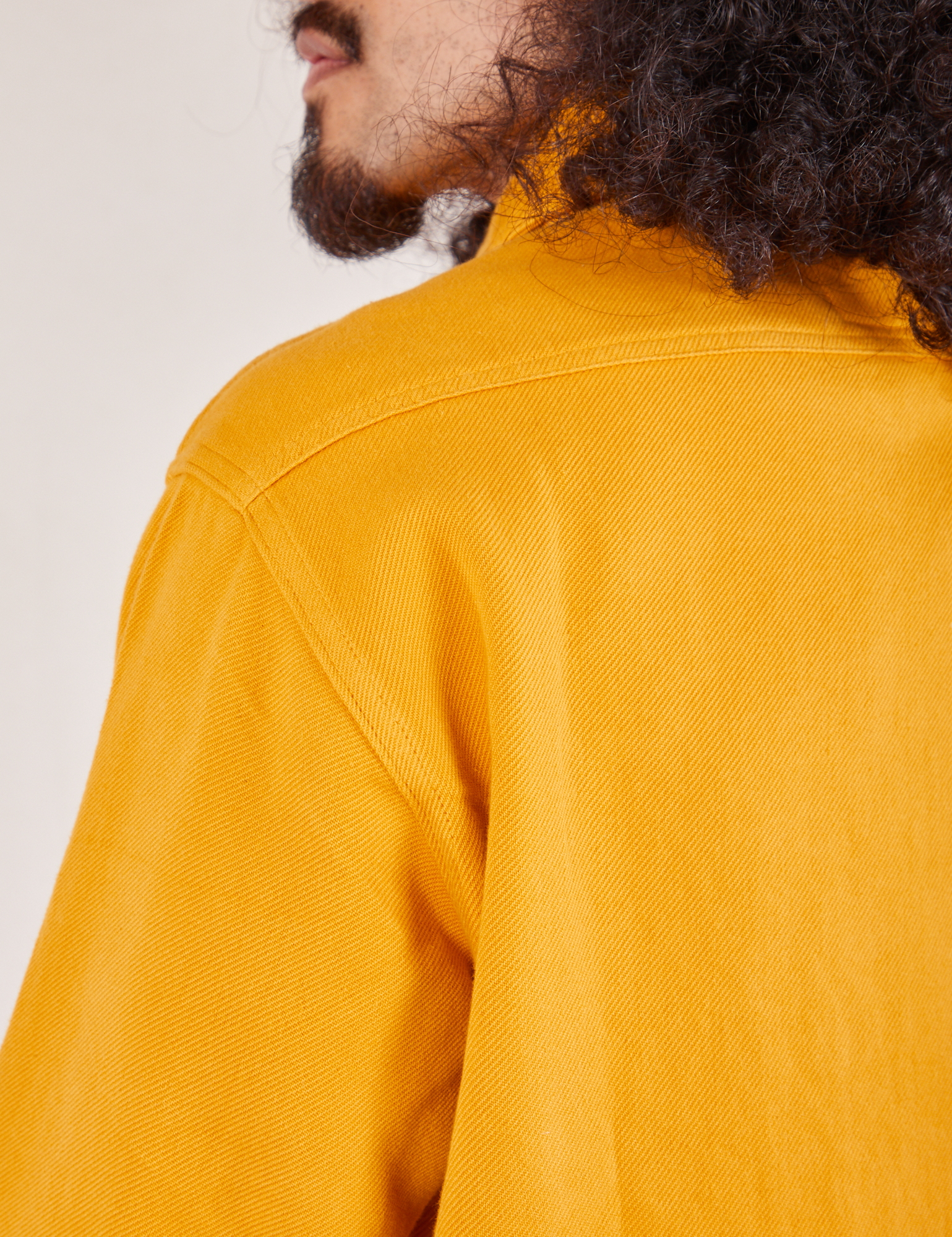 Back shoulder close up of Flannel Overshirt in Mustard Yellow on Jesse