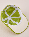 Dugout Corduroy Hat in Gross Green flipped over. White satin under-bill