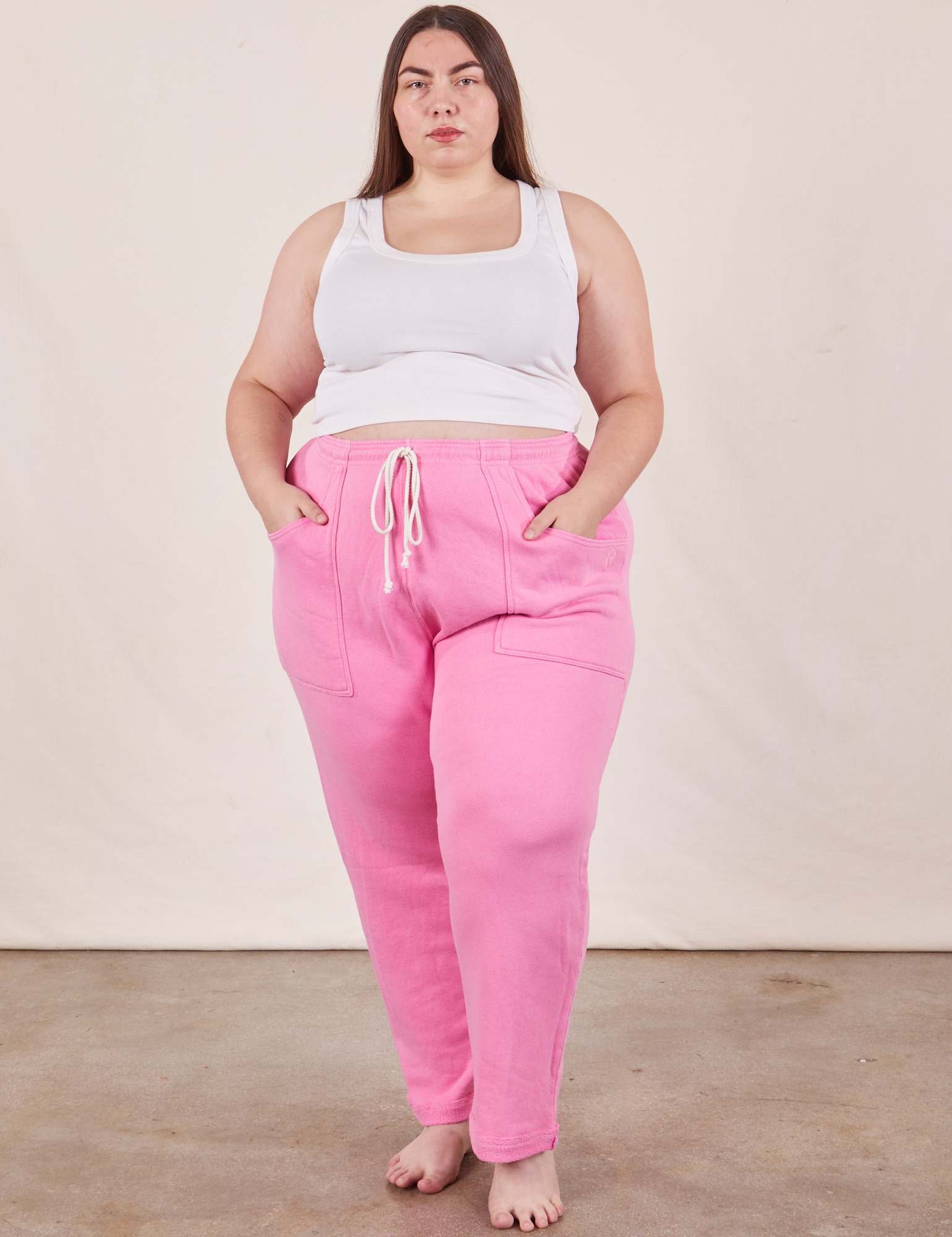 Marielena is 5&#39;8&quot; and wearing 2XL Cropped Rolled Cuff Sweatpants in Bubblegum Pink paired with vintage off-white Cropped Tank Top