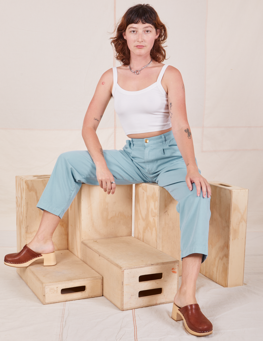 Alex is wearing Heavyweight Trousers in Baby Blue and vintage off-white Cropped Cami