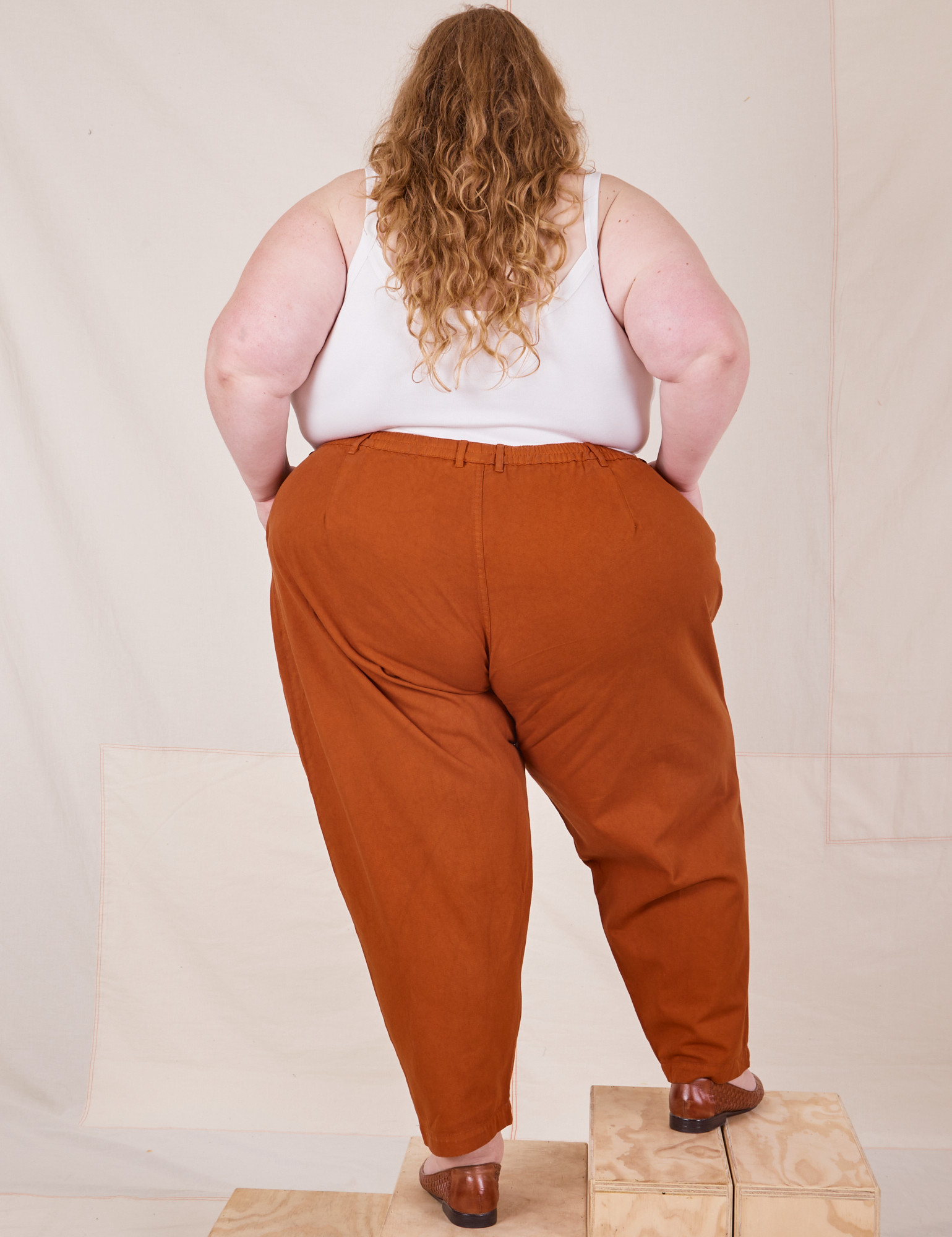 Back view of Heavyweight Trousers in Burnt Terracotta worn by Catie