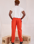 Back view of Mid-Rise Pleated Trousers in Chili Red and Organic Vintage Tee in vintage tee off-white on Issac