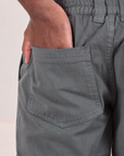 Mid-Rise Work Pants in Slate Grey close up of Issac's hand in the back pocket