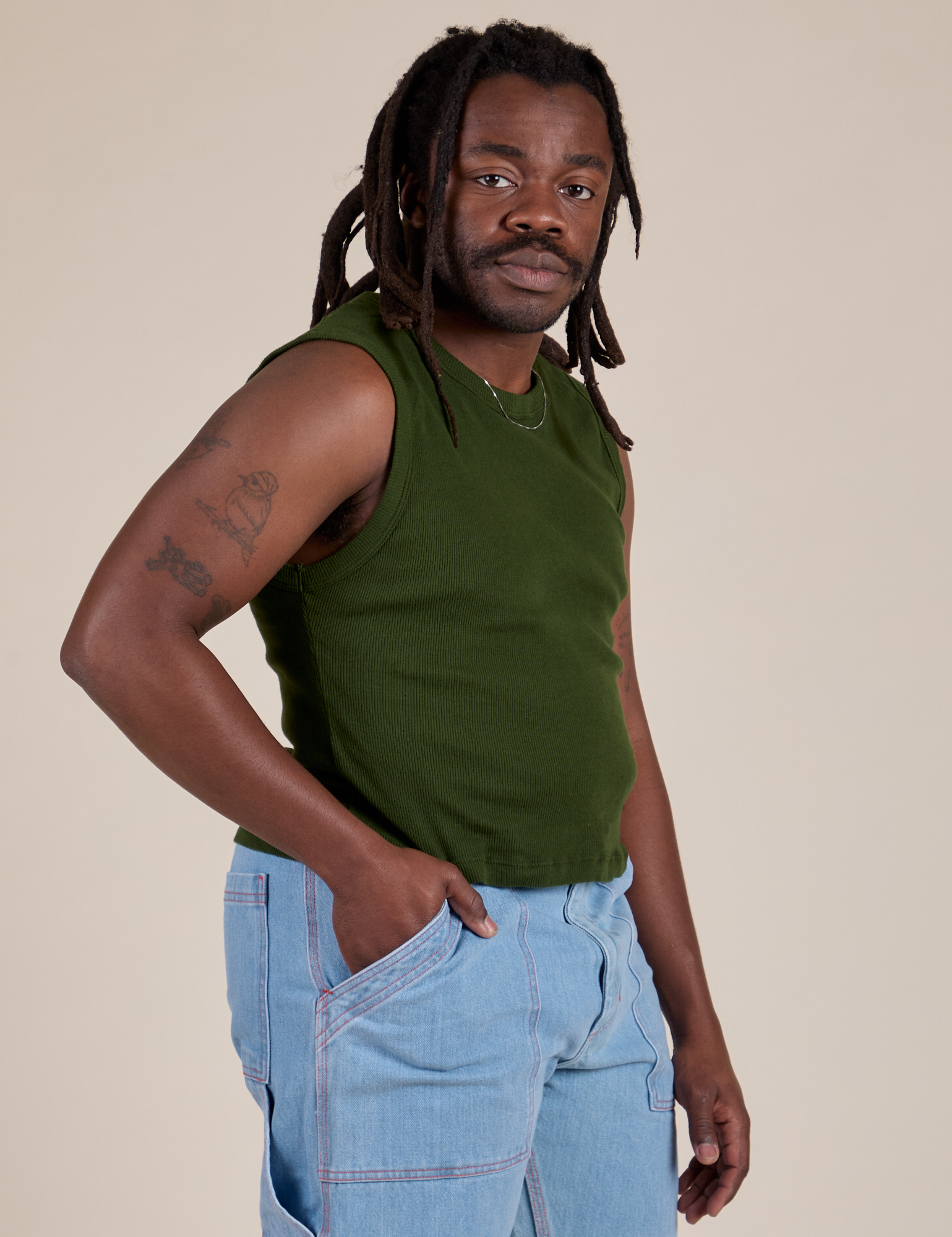 Angled front view of Muscle Tee in Evergreen on Demi