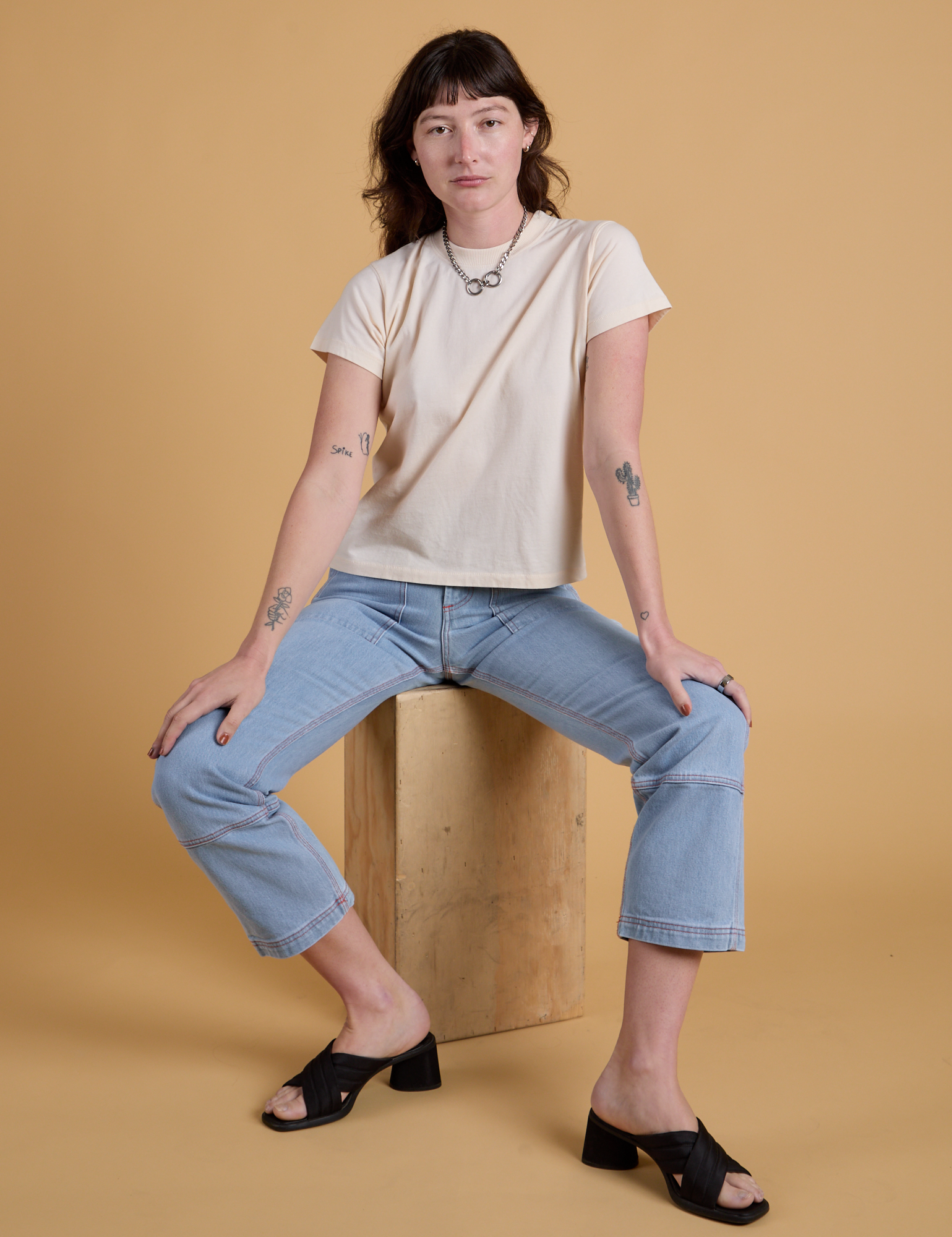 Alex is wearing Organic Vintage Tee in Vintage Off White and light wash Carpenter Jeans