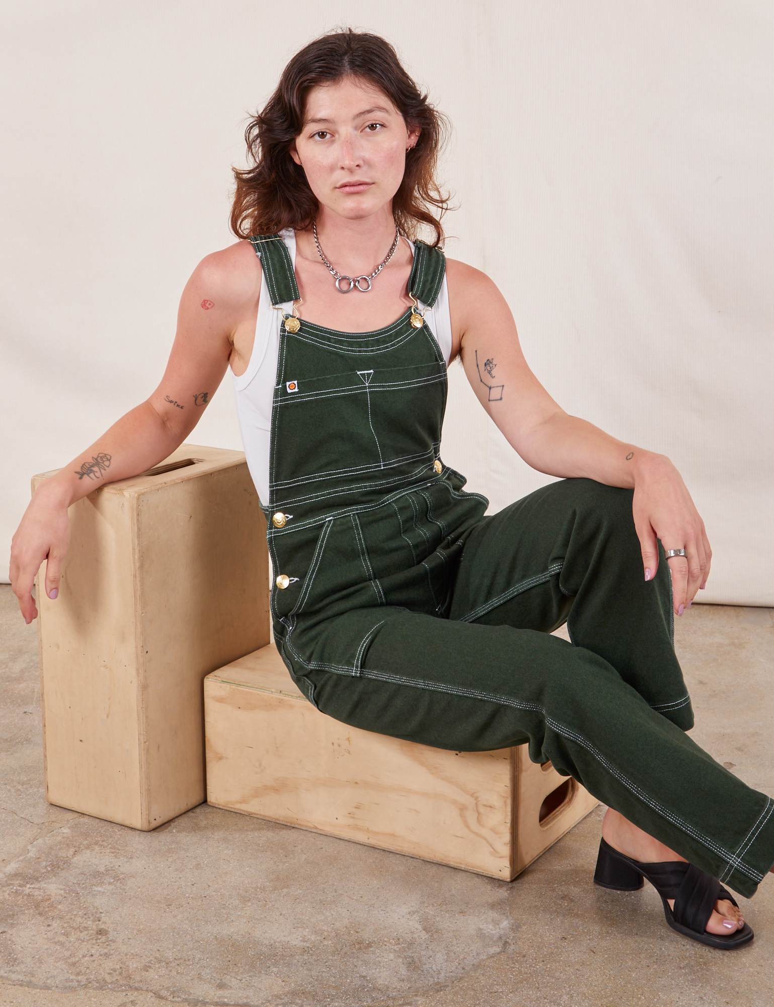 Alex is wearing Original Overalls in Swamp Green