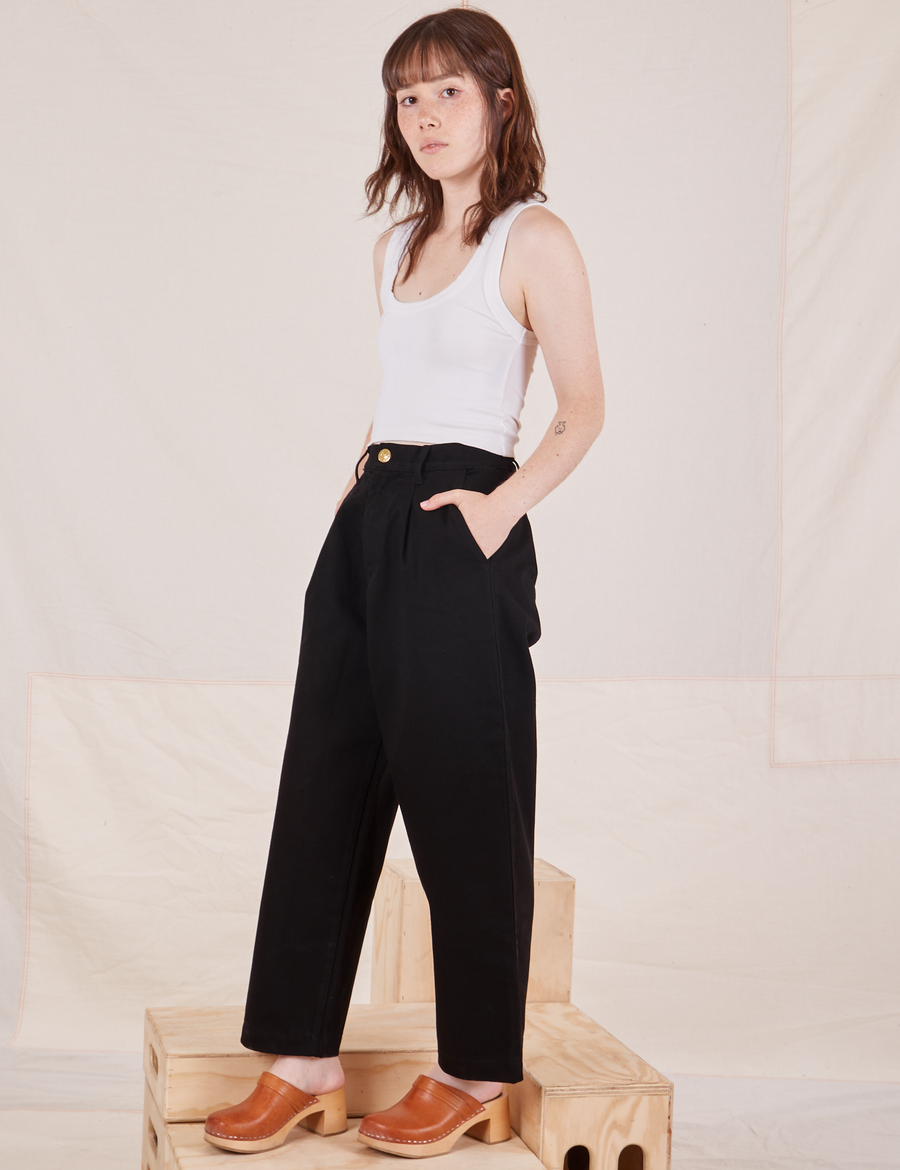 Side view of Denim Trouser Jeans in Black and vintage off-white Cropped Tank Top on Hana