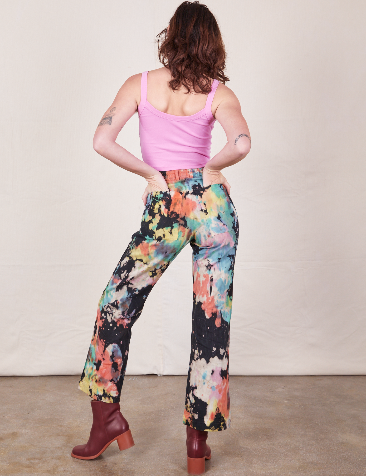Back view of Western Pants in Rainbow Magic Waters and bubblegum pink Cami on Alex
