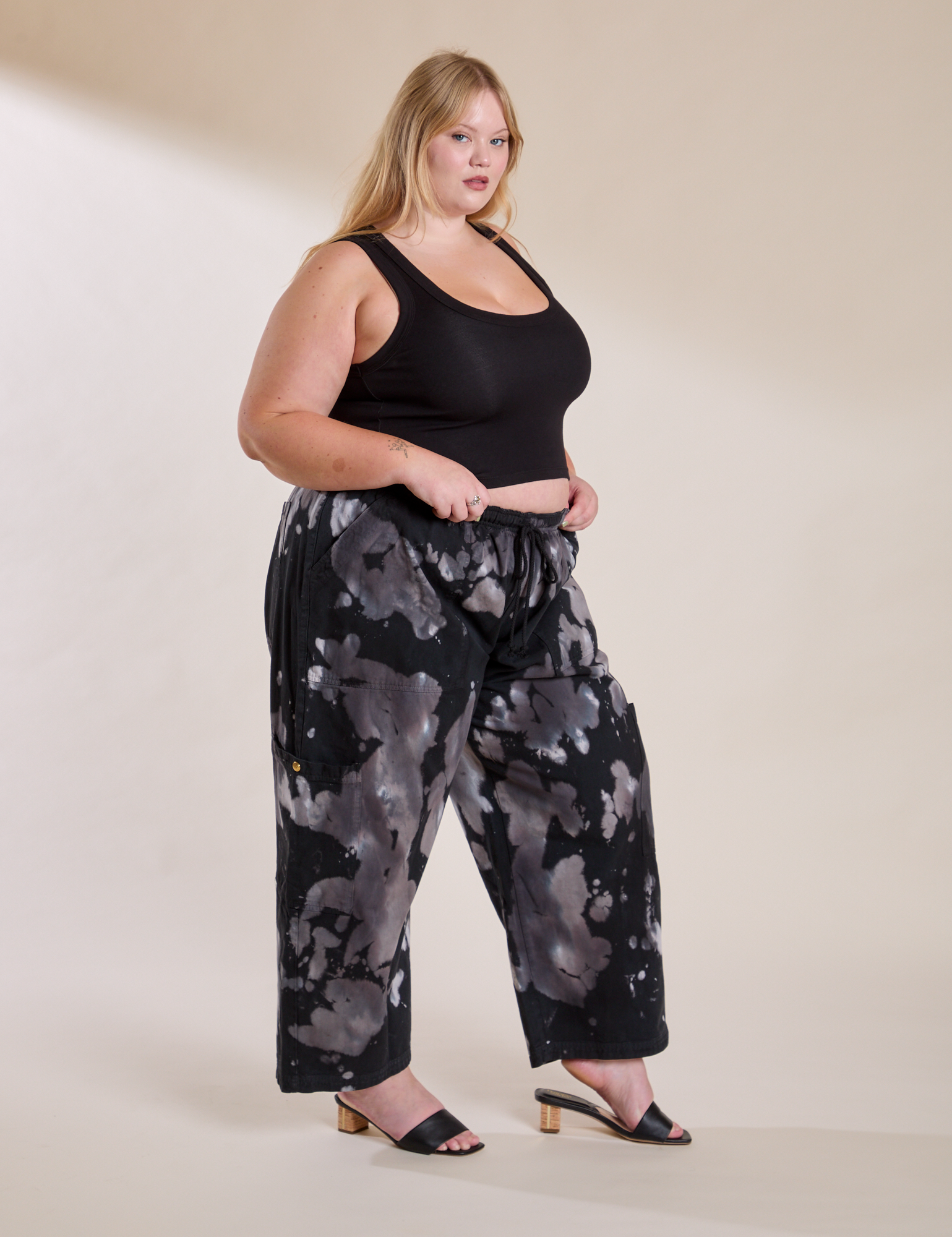 Angled front view of Magic Waters Drop Pocket Pants in Ink Blot and black Cropped Tank on Juliet