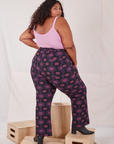 Angled back view of Western Pants in Purple Tile Jacquard and bubblegum pink Cami on Morgan