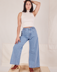 Betty is 5'8" and wearing XXS Indigo Wide Leg Trousers in Light Wash paired with vintage off-white Sleeveless Turtleneck