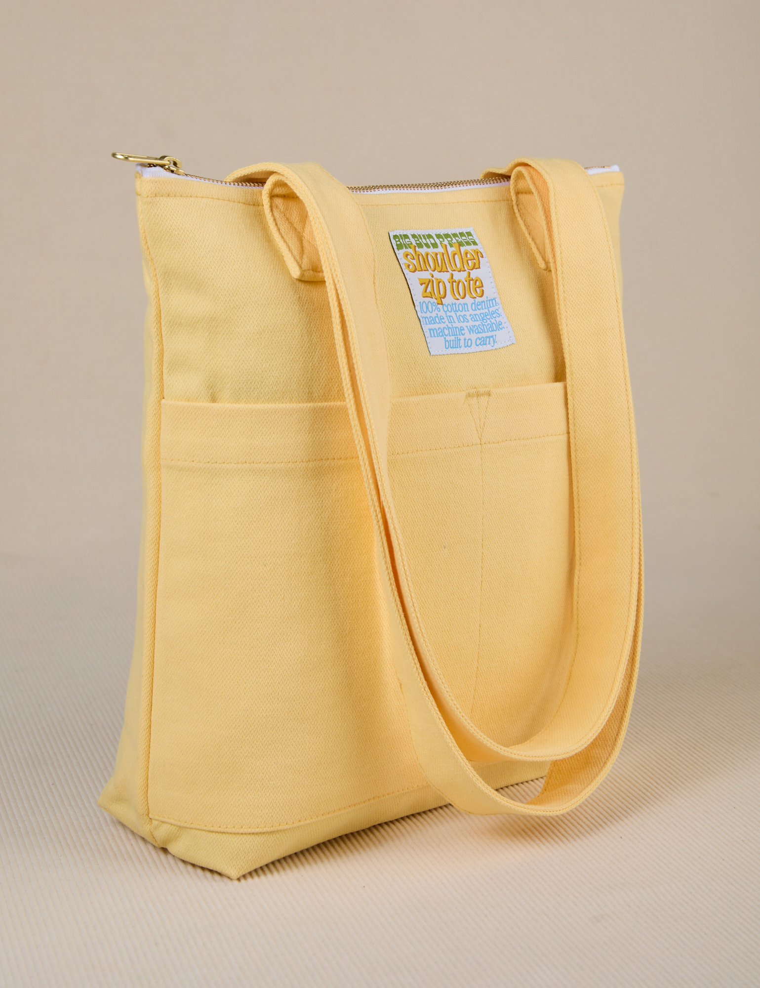 Angled view of Over-Shoulder Zip Mini Tote in Butter Yellow