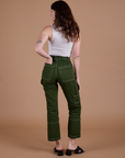 Carpenter Jeans in Evergreen back view on Alex