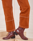 Carpenter Jeans in Burnt Terracotta pant leg close up on Jesse